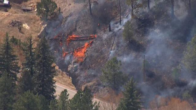 Fire near US 285 100 percent contained